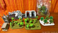 Group shot of all terrain pieces: tower, ruins, palm bases, tree base, bag of foliage