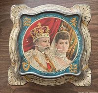 Top view showing crowned royal couple on lid