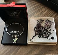 Silver plate Swarovski crystal bangle in Truly Inspired box beside seed-bead cuff in box