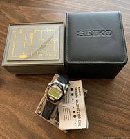 Three watches with respective boxes and manual
