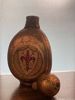 Front view showing leather-wrapped decanter and stopper with Florentine crest