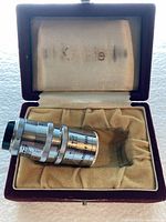 Lens in open case showing interior branding and lens details