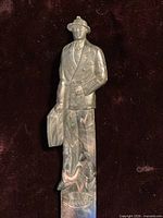 Marbleized plastic letter opener showing Fuller Brush man handle