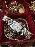 Citizen watch atop silver chain in jewelry box compartment
