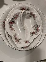 Stacked view of the three Lavender Rose serving dishes