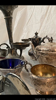 Angled view highlighting sugar bowl gilt interior, creamer and other serveware