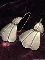 Front view of both earrings showing fan design and hooks