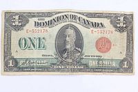 Obverse of 1923 Dominion of Canada $1 banknote showing serial number, portrait, red seal and overall wear