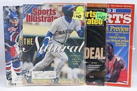 Front view of four bagged magazines showing covers and titles