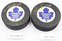Autographed Toronto Maple Leafs pucks by Mike Palmateer and Felix Potvin side by side, signatures visible