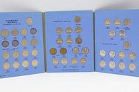 Interior view of three-panel album showing labeled slots and installed coins