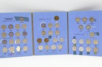 Album fully open showing three panels with labeled slots and inserted coins