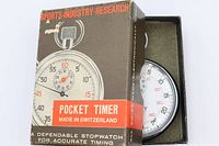 Box lid displaying Sports-Industry-Research Pocket Timer branding with stopwatch partially visible in foam insert