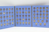 Entire blue tri-fold folder opened showing all three panels with coins inserted and empty slots