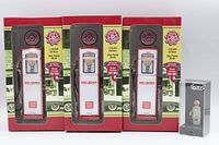 Front view of three boxed Red Crown gas pump banks and one boxed CTX figure