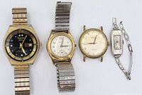 Front view of all four watches showing dials, cases, and bands
