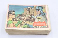 Stack of vintage trading cards, top card Batman "Victorious Duo"