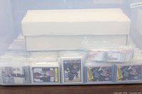 Clear tote containing sleeved Wayne Gretzky cards and long storage box