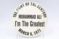 Front of round Muhammad Ali commemorative button showing full printed text