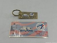 Ticket stub and keychain together showing overall condition