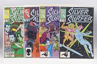 Front view of four bagged Silver Surfer comics side by side