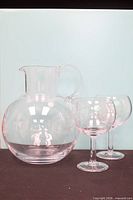 Pitcher and two of the wine glasses front view