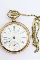 Front view showing Waltham dial, hands and attached chain