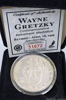 Obverse of medallion in box with certificate showing limited edition number 31072 and Highland Mint branding