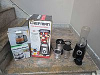 All five boxed and unboxed appliances on stair landing