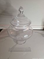 Jar fully assembled with lid in place beside ruler for scale