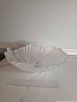 Top view of frosted glass bowl showing swirl pattern and scalloped edge