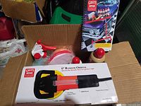 Polisher box, pads, liquids, spray trigger, handbook visible inside cardboard box