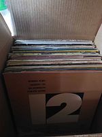 Front stack in box showing Robben Ford/Gilberto Gil/Jim Morrison/Pointer Sisters compilation cover