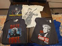 All four graphic T-shirts laid out flat displaying front designs