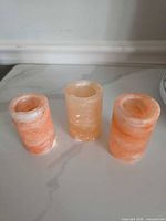 Front view of three cylindrical Himalayan salt holders