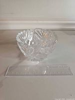 Small cut crystal bowl beside ruler showing diameter