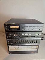 Front view of stacked Technics SA-007 components showing tuner, control amp, equalizer and power amp