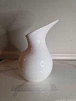 front view of white glossy pitcher-vase