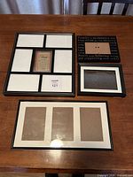 Four black frames displayed on table showing relative sizes and collage openings