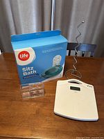 Boxed Life Sitz Bath, clear toothbrush holder, white WW digital scale on table