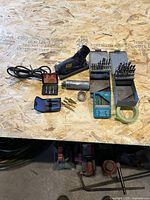 Overall lot showing Drill Doctor, drill bit boxes, step bits, extractors, reamer, loose bits