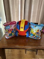 Wagon flanked by two block bags on table