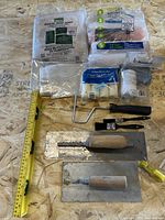 Entire lot showing drop sheets, roller accessories, trowels, level and scrapers