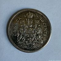 Reverse of 1960 Canadian 50 cent coin showing coat of arms
