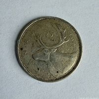 Reverse of 1964 Canadian 25-cent coin showing caribou and denomination