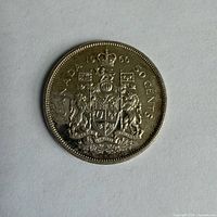 Reverse showing Canadian Coat of Arms, legends and date