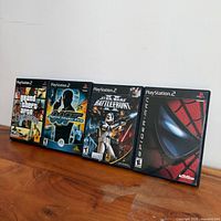 All four PS2 game cases standing side by side