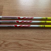 Three ProForce V2 shafts laid side-by-side showing graphics