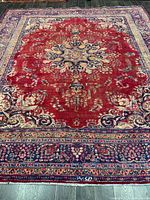 Full view of rug showing central medallion, border and wear