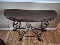 Full view of half-moon console table showing wood top and iron base